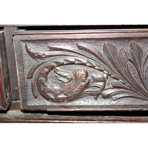 124 - An unusual antique 2 over 5 carved oak chest of drawers with brass fittings, approx 108cm wide x 54c... 