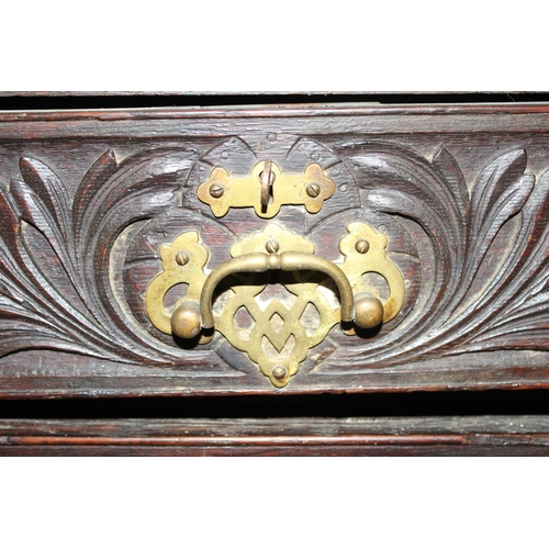 124 - An unusual antique 2 over 5 carved oak chest of drawers with brass fittings, approx 108cm wide x 54c... 