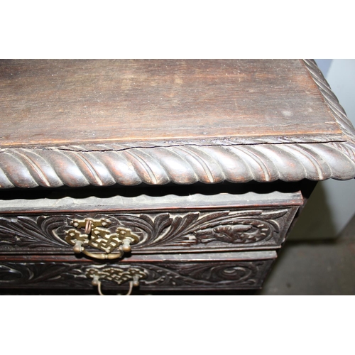 124 - An unusual antique 2 over 5 carved oak chest of drawers with brass fittings, approx 108cm wide x 54c... 