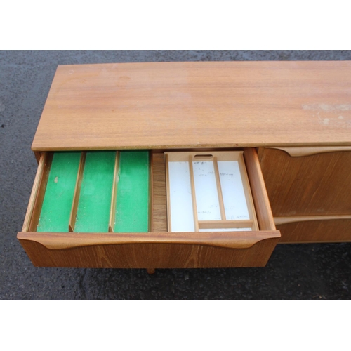 2 - A retro mid-century S-Form teak sideboard by Sutcliffe of Todmorden, 3 drawers to the left, dropdown... 