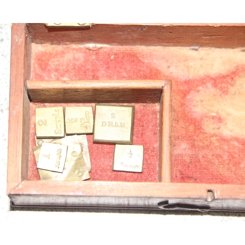 664 - Antique apothecary scales in box with some weights incl half scruple - 2 scruple and a half dram and... 