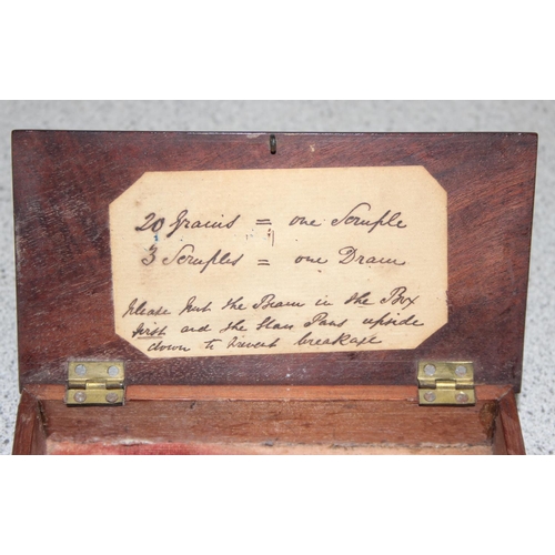 664 - Antique apothecary scales in box with some weights incl half scruple - 2 scruple and a half dram and... 