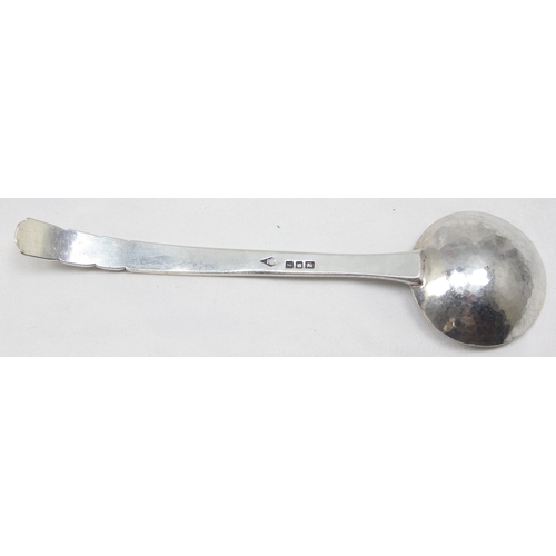 1047 - A modern hand made silver ladle or spoon with chased leaf pattern to the curved handle and hammered ... 