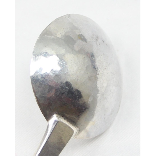 1047 - A modern hand made silver ladle or spoon with chased leaf pattern to the curved handle and hammered ... 