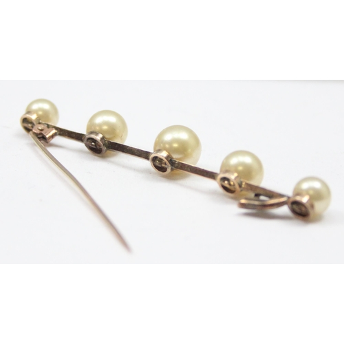 1107 - An antique 9ct gold bar brooch set with a line of 5 faux pearls, seemingly unmarked but XRF tests as... 