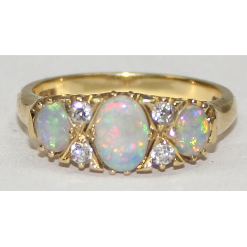 1108 - An 18ct gold trilogy opal and diamond ring, 3 opals are separated by 2 pairs of diamonds, marked and... 