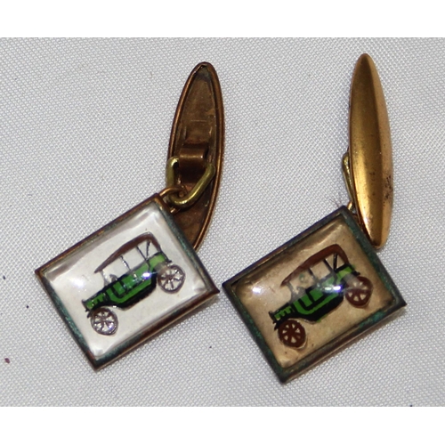 1137 - A pair of early 20th century Essex crystal type gilt metal cufflinks depicting an early motorcar