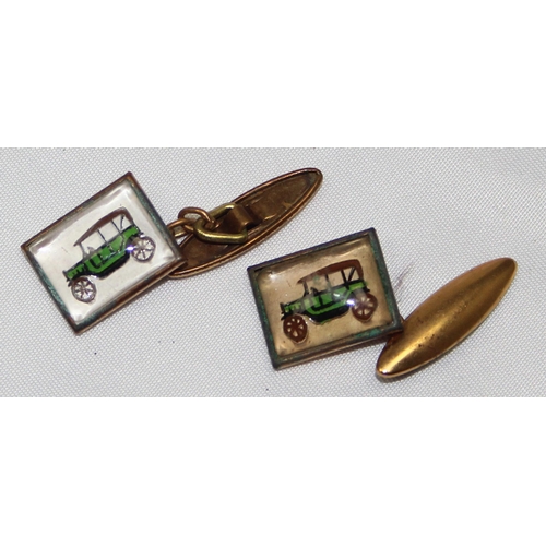 1137 - A pair of early 20th century Essex crystal type gilt metal cufflinks depicting an early motorcar