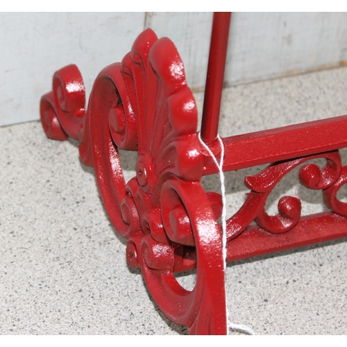 275 - A red painted cast iron Wellington boot rack, approx 56cm wide