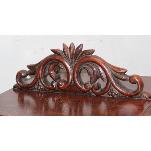 276 - An antique style table top mahogany bookcase with decorative carved top, approx 32cm square x 65cm t... 