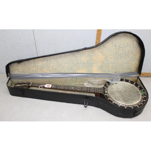 603 - An early 20th century 4 string banjolele in case, seemingly unmarked, with some contemporary sheet m... 