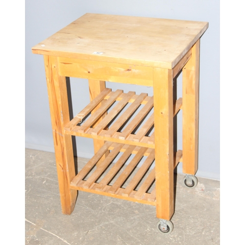 84 - Pine kitchen island or chopping table with wheels, approx 60cm wide x 50cm deep x 85cm tall