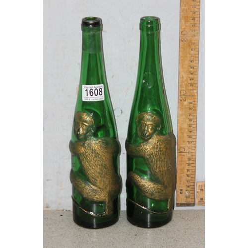 1878 - A pair of vintage embossed and gilt green glass bottles decorated with a clinging monkey, a large re... 