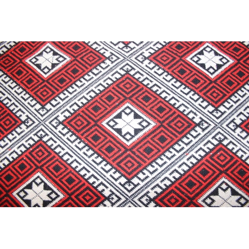 201 - A vintage Welsh style reversible blanket of red, black and white, approx. 215cm x 240cm