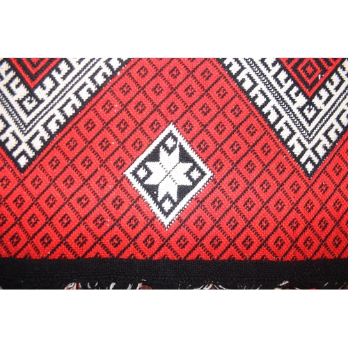 201 - A vintage Welsh style reversible blanket of red, black and white, approx. 215cm x 240cm