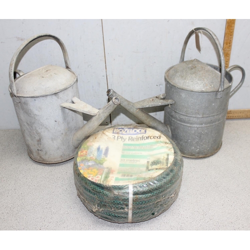 309 - 2 galvanised watering cans and a 10m garden hosepipe (3)