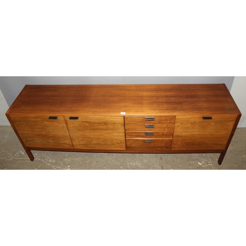 8 - A retro mid-century Meredew sideboard, a bank of 4 drawers flanked by 3 cupboards, approx 206cm wide... 