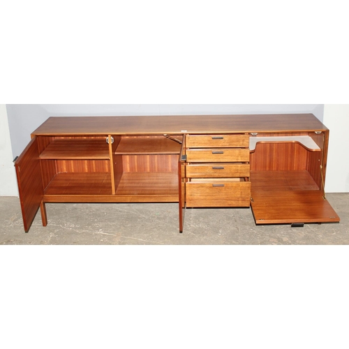 8 - A retro mid-century Meredew sideboard, a bank of 4 drawers flanked by 3 cupboards, approx 206cm wide... 