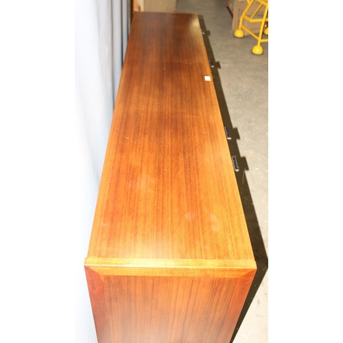 8 - A retro mid-century Meredew sideboard, a bank of 4 drawers flanked by 3 cupboards, approx 206cm wide... 