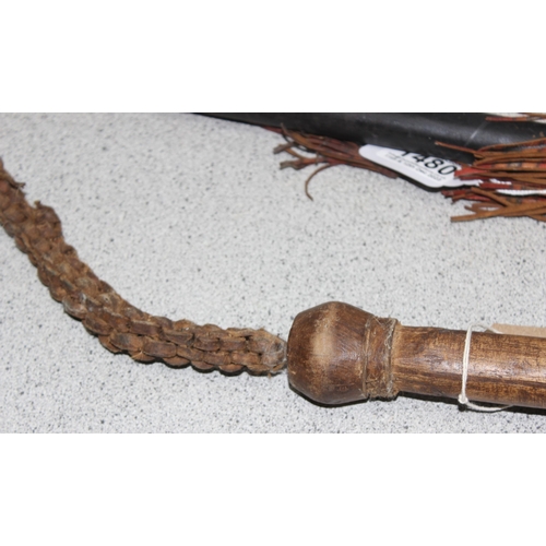 1480 - A vintage woven leather bull whip with wooden handle and an African leather bound walking staff with... 