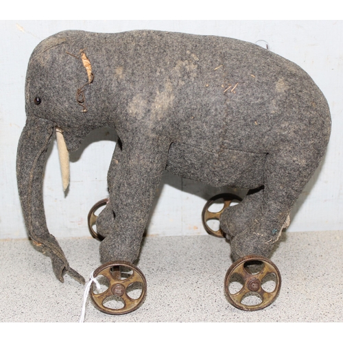 1547 - A well-loved vintage Steiff grey elephant on wheels, approx 25cm long