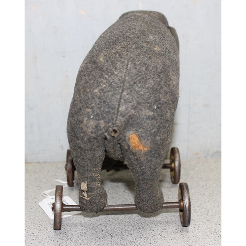 1547 - A well-loved vintage Steiff grey elephant on wheels, approx 25cm long