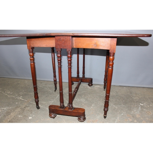 160 - An antique mahogany dropleaf table on turned legs, approx 113cm wide x 84cm deep x 73cm tall