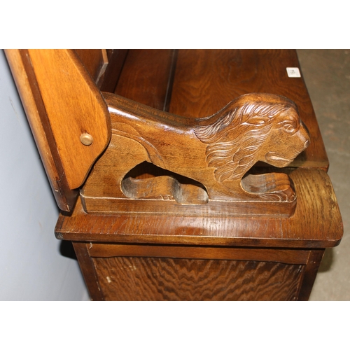 164 - A vintage carved oak Monk's bench or storage box with lion supports, approx 96cm wide x 42cm deep x ... 