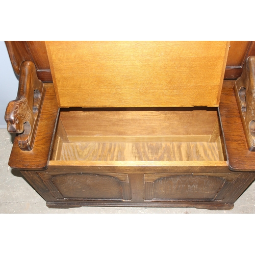 164 - A vintage carved oak Monk's bench or storage box with lion supports, approx 96cm wide x 42cm deep x ... 