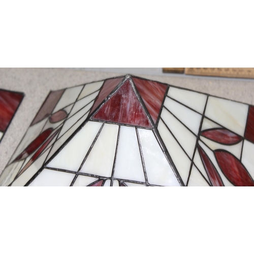 253 - A pair of red and cream Tiffany style glass ceiling shades with chain fixings, approx 32cm x 32cm