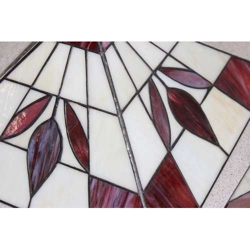 253 - A pair of red and cream Tiffany style glass ceiling shades with chain fixings, approx 32cm x 32cm