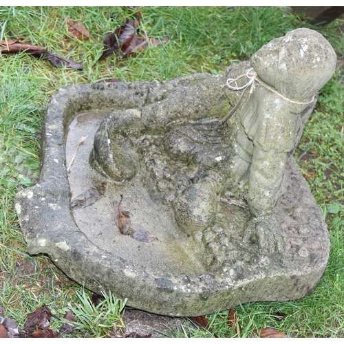 316 - A weathered concrete birdbath formed as a seated male, approx 48cm wide