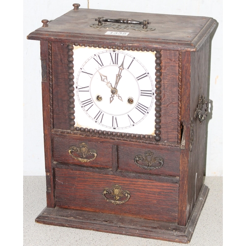 1338 - An unusual antique oak table top collectors cabinet with mechanical clock approx. 35cm tall