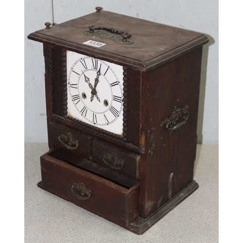 1338 - An unusual antique oak table top collectors cabinet with mechanical clock approx. 35cm tall