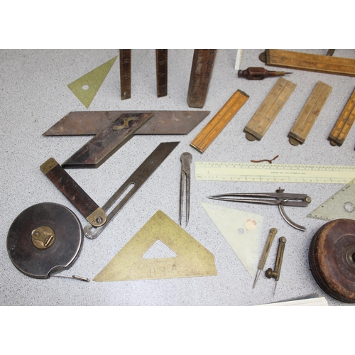 671 - Qty of vintage measuring equipment to include set squares, rulers and tape measures