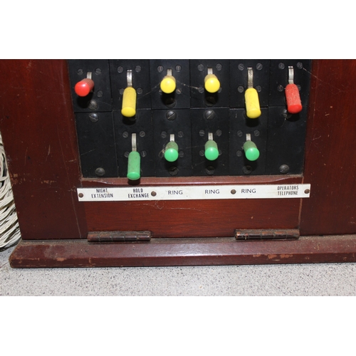 672 - Vintage mahogany cased telephone exchange/switchboard with receivers