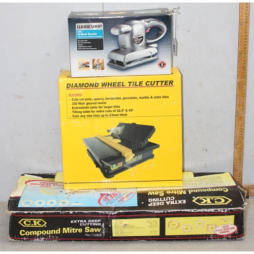 823 - 3 power tools to include a C.K compound mitre saw, diamond wheel tile cutter and an orbital sander