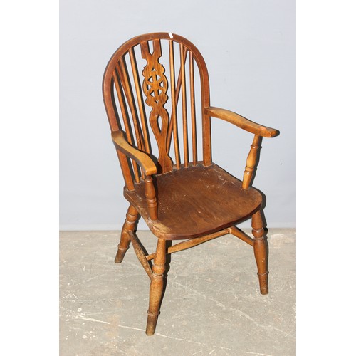 31 - A vintage wheel back kitchen armchair