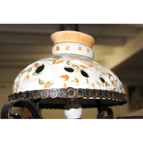 252 - 2 large wrought iron and pottery hanging lamps