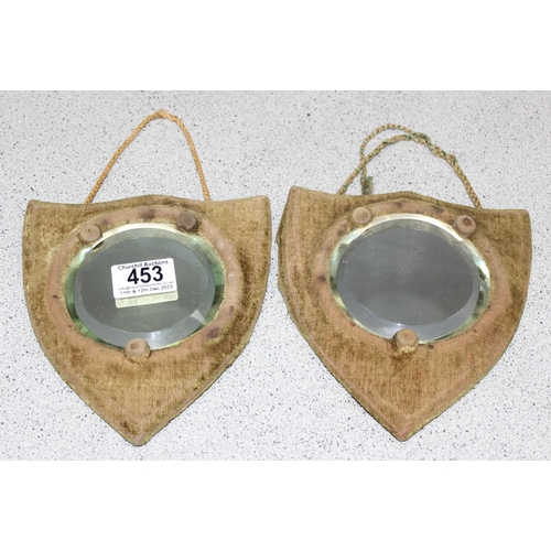 453 - Pair of bevelled edge round mirrors on shield shaped backings, approx 18cm tall