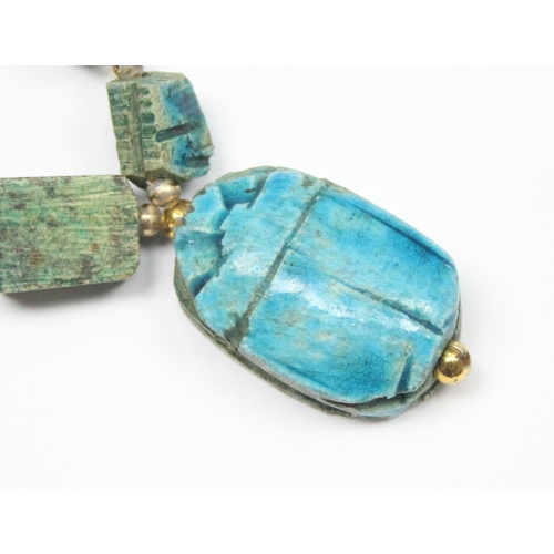 1140 - An unusual turquoise glazed ceramic scarab beetle formed as a pendant on chain formed from other sma... 