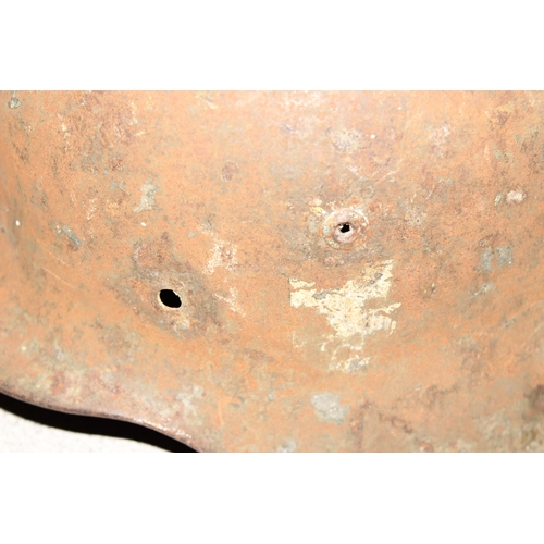 1470 - A WW2 period German helmet, believed to be an M35, no liner and remnants of decals, near relic condi... 