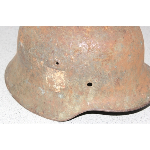 1470 - A WW2 period German helmet, believed to be an M35, no liner and remnants of decals, near relic condi... 