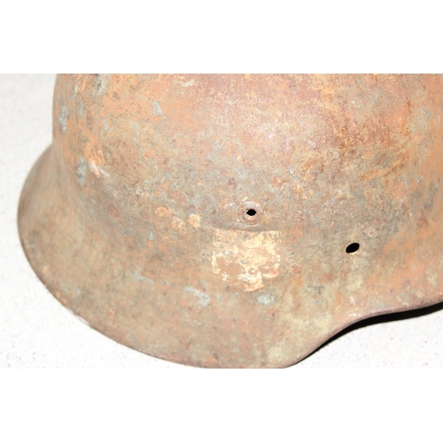 1470 - A WW2 period German helmet, believed to be an M35, no liner and remnants of decals, near relic condi... 