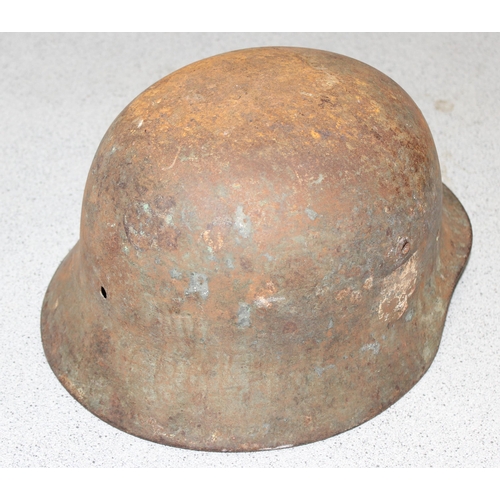 1470 - A WW2 period German helmet, believed to be an M35, no liner and remnants of decals, near relic condi... 