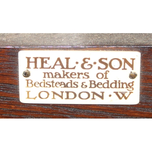 61 - An early 20th century Mahogany bed head and footboard by Heal & Son of London, with side rails but n... 