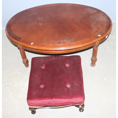 63 - A good quality modern oval coffee table and a small red velvet topped footstool (2)