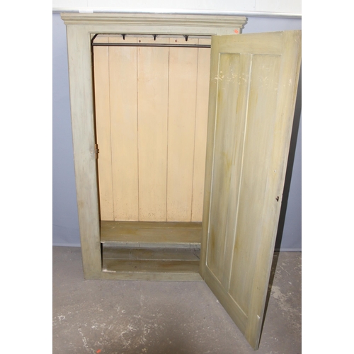 82 - A vintage painted pine hall cupboard with interior low shelf and various hangers, likely late 19th o... 
