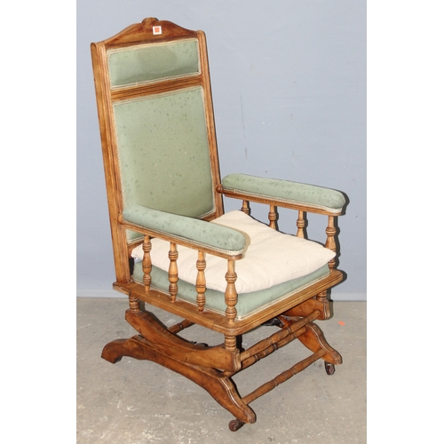 37 - An antique American style rocking chair with light green upholstery