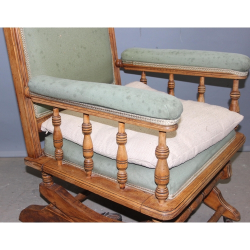 37 - An antique American style rocking chair with light green upholstery